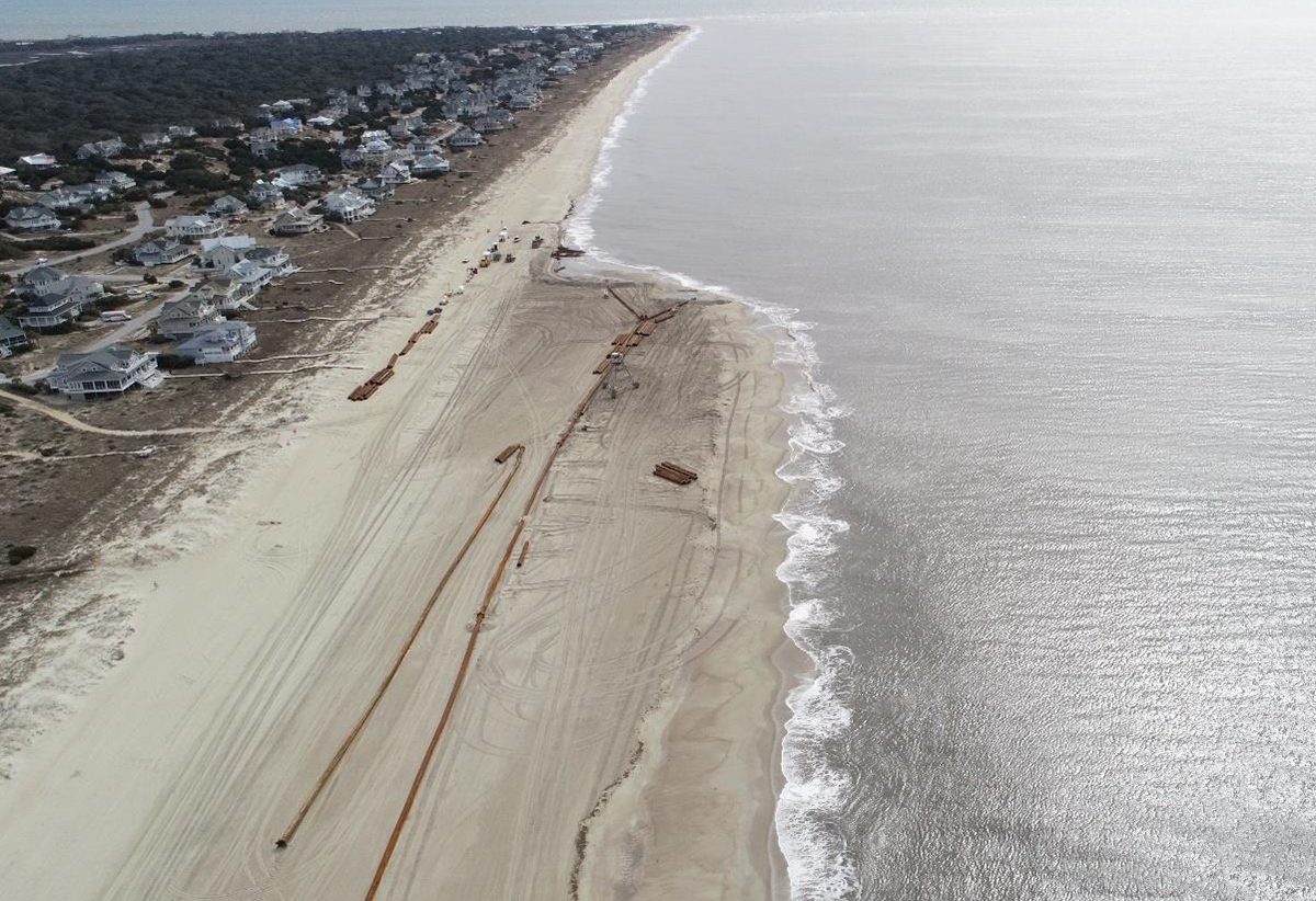Drone imagery from March 2, 2021, during a dredging and beach nourishment project, shows Bald Head Island with The Shoals Club near top center. Photo: Village of Bald Head Island