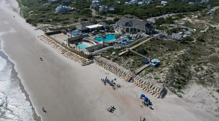 This Bald Head Island drone image from June 17, 2022, shows The Shoals Club and the sandbag revetment on the beachfront.