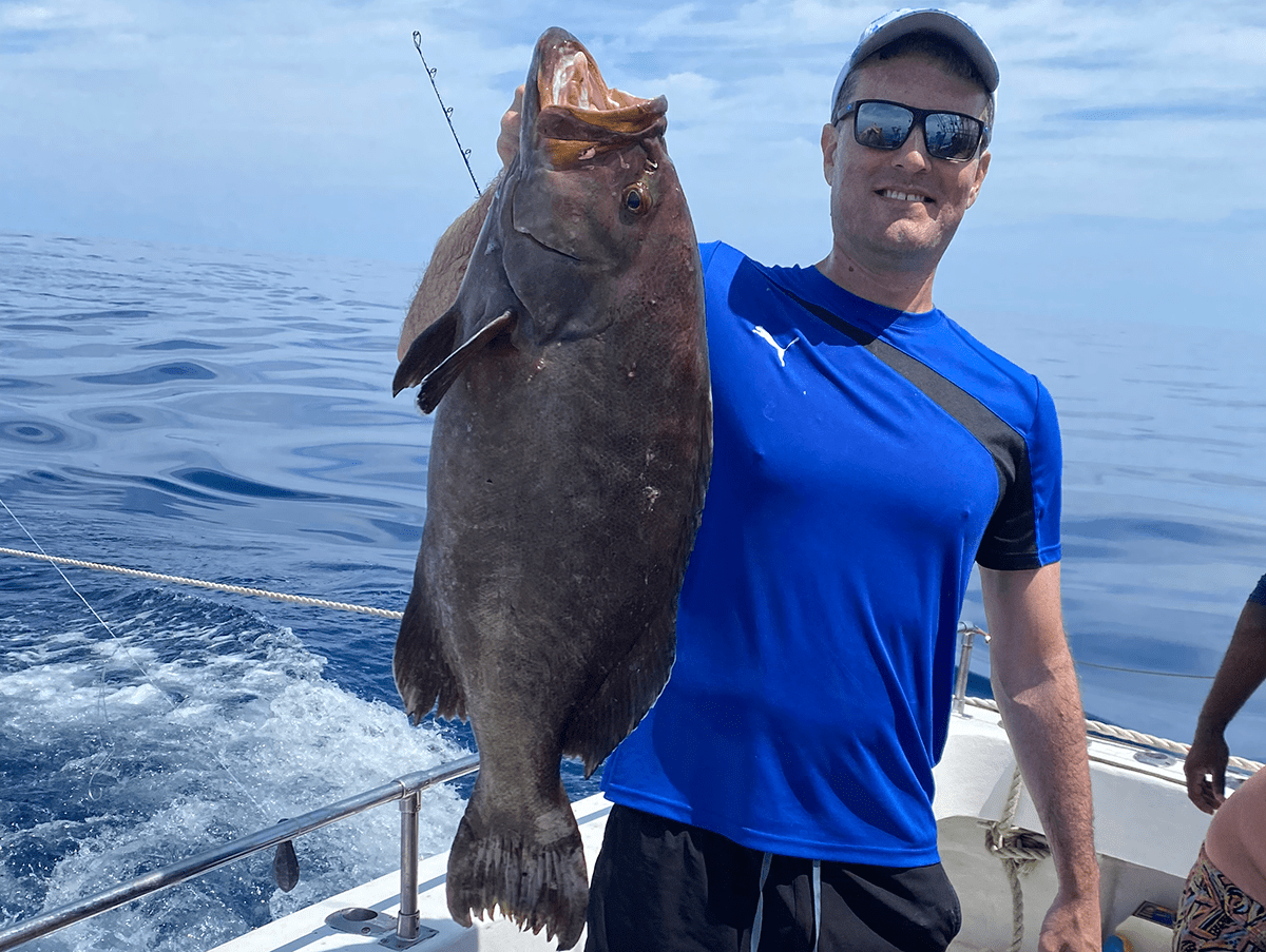 Christopher Hyche holds his state record yellowmouth grouper. Photo: Division of Marine Fisheries