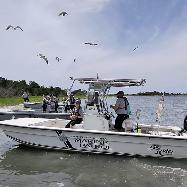 The 11 middle schoolers participating in the first North Carolina Marine Patrol Junior Academy ready June 13 for an afternoon on the water after lunch at Rachel Carson Reserve in Beaufort. Photo: Jennifer Allen