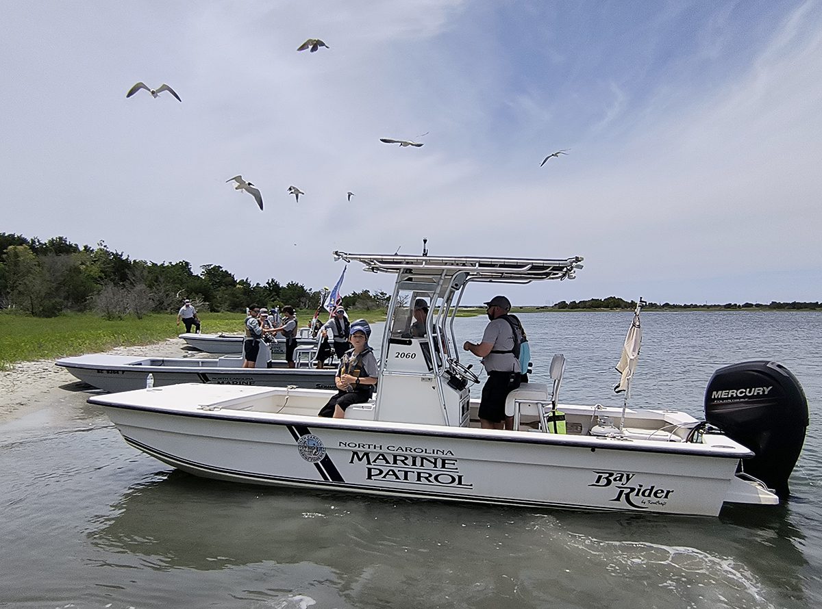 The 11 middle schoolers participating in the first North Carolina Marine Patrol Junior Academy ready June 13 for an afternoon on the water after lunch at Rachel Carson Reserve in Beaufort. Photo: Jennifer Allen