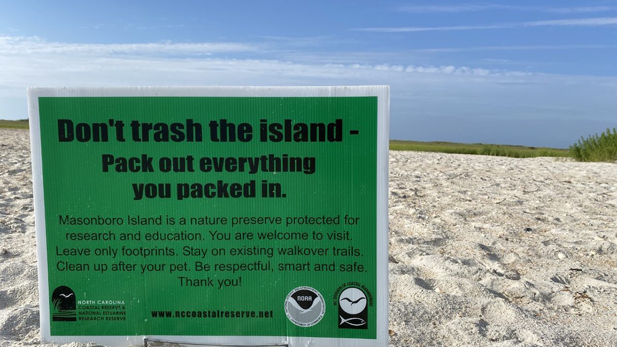 This sign reminds visitors to carry out all their trash at the Masonboro Island Reserve. Photo: Division of Coastal Management