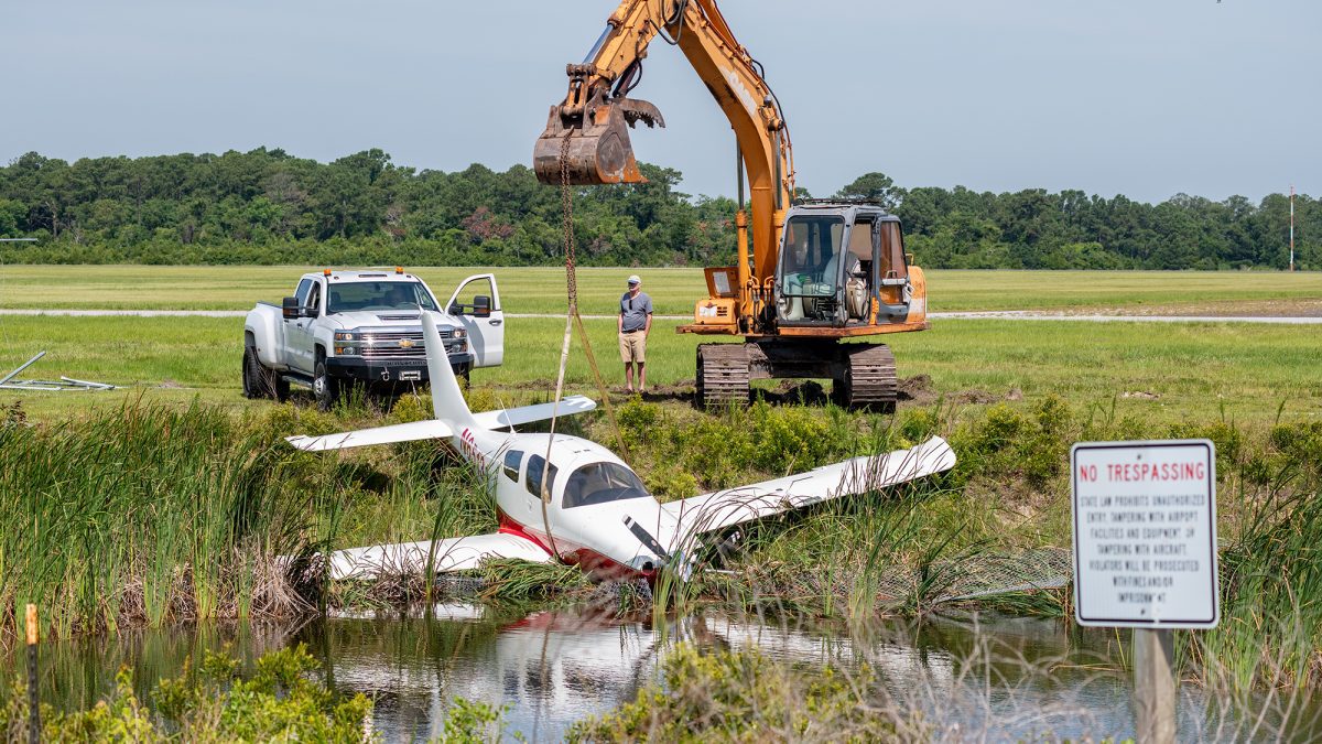 A bottom-wing private aircraft rests in a drainage ditch Sunday morning after leaving the runway Saturday evening at Michael J. Smith Field, a general aviation airport, in Beaufort. Photo: Dylan Ray