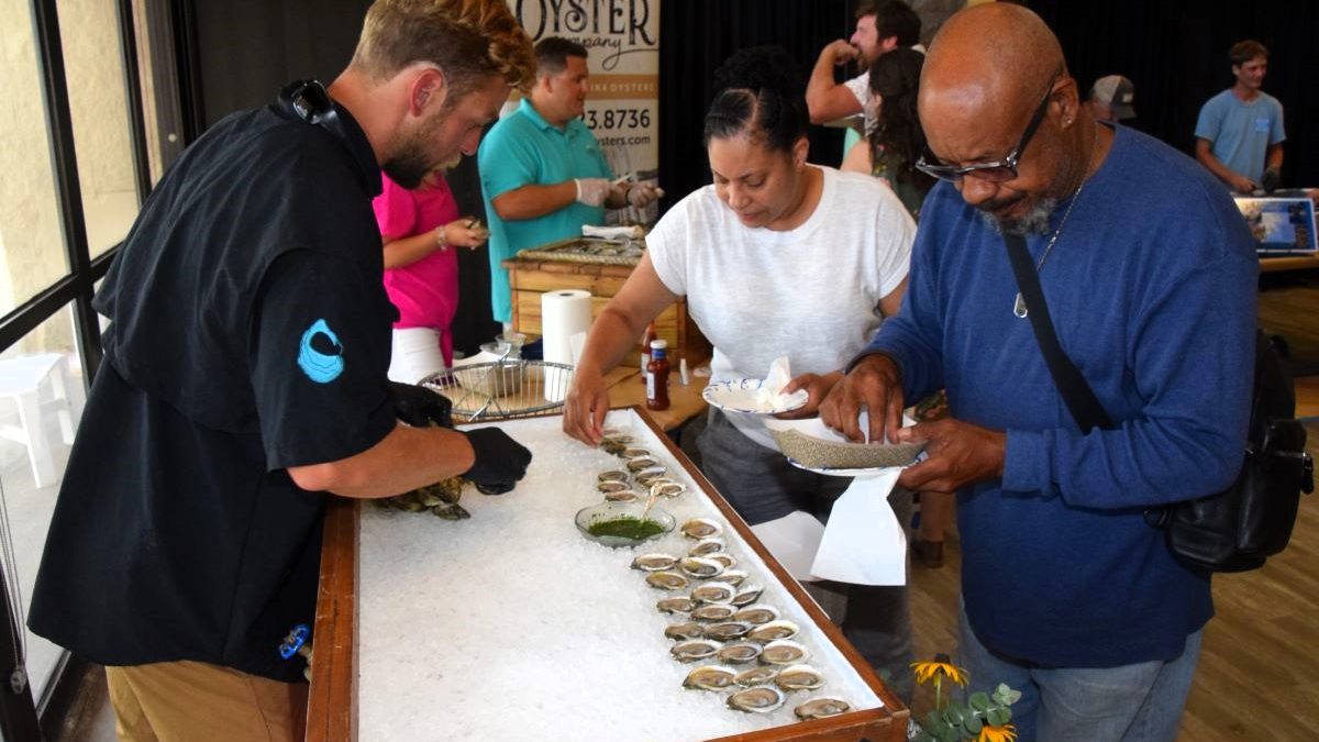 Attendees select their oysters during the 2023 Taste of the Coast. Photo: Mark Hibbs