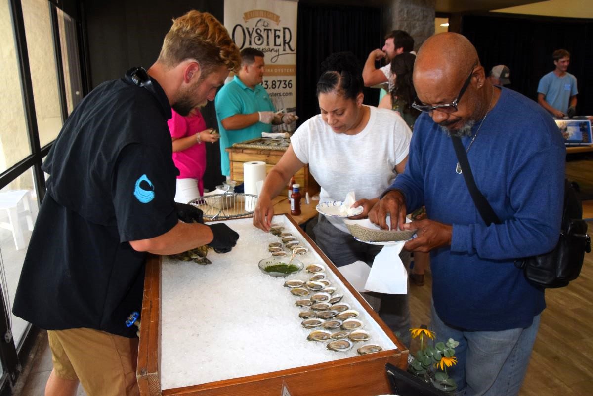 Attendees select their oysters during the 2023 Taste of the Coast. Photo: Mark Hibbs