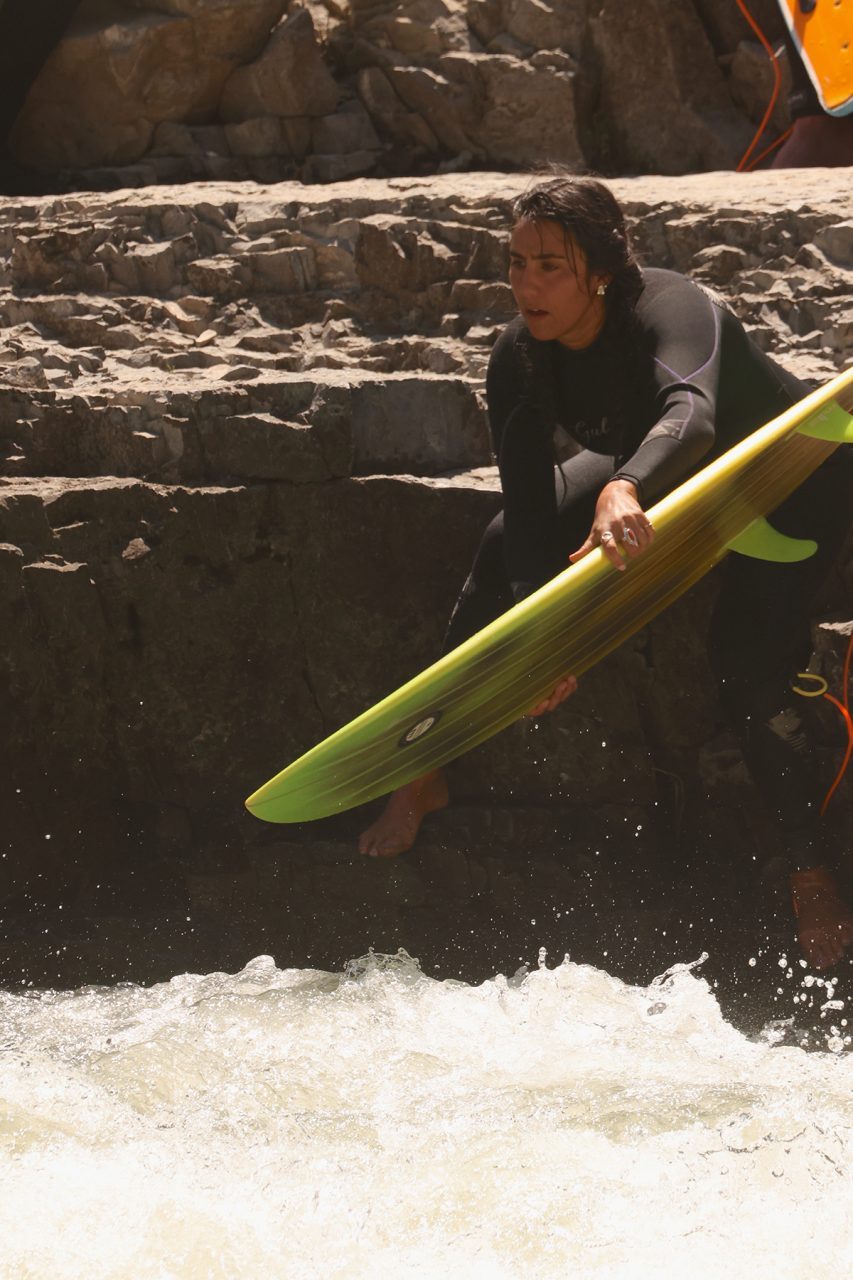 Natalie Catania jumps into the Snake River with her surfboard. Photo: Sam Bland