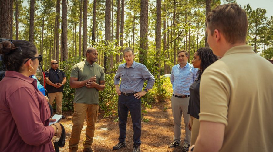 Environmental Protection Agency Administrator Michael Regan, center left, and Gov. Roy Cooper are encircled Tuesday by attendees at a press event in the Green Swamp Preserve. Photo: Courtesy, EPA