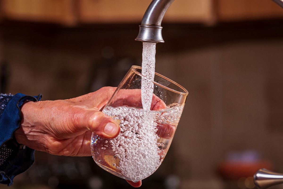 Tap water flows from a faucet into a glass. Photo: EPA, Eric Vance
