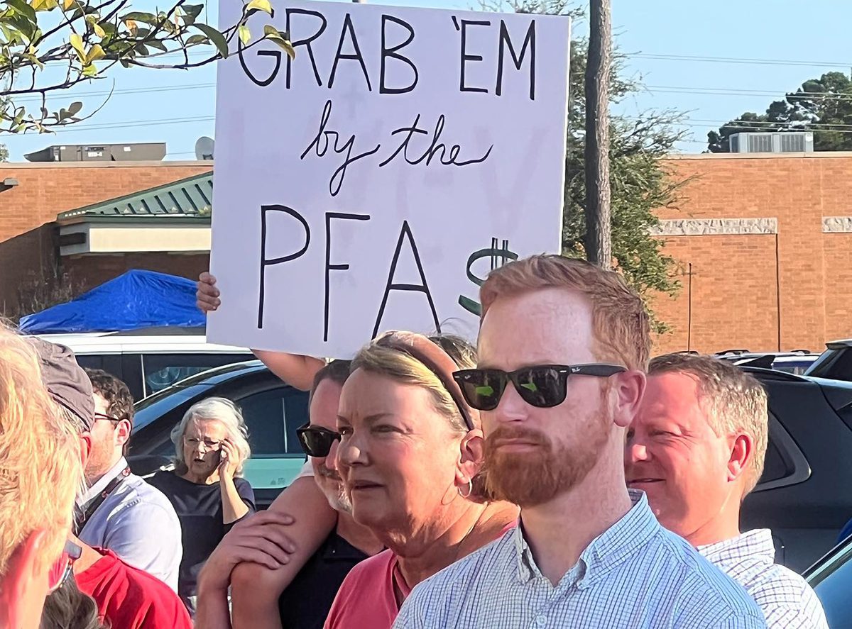 Protestors at an open house event in 2022 Leland hold signs expressing their concerns about Chemours expanding productions at its Fayetteville Works plant. Photo: Courtesy, Clean Cape Fear