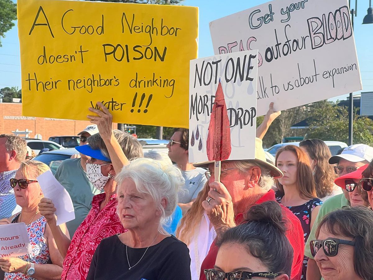 Protestors at an open house event in 2022 in Leland hold signs expressing their opinions about Chemours expanding productions at its Fayetteville Works plant. Photo: Courtesy, Clean Cape Fear