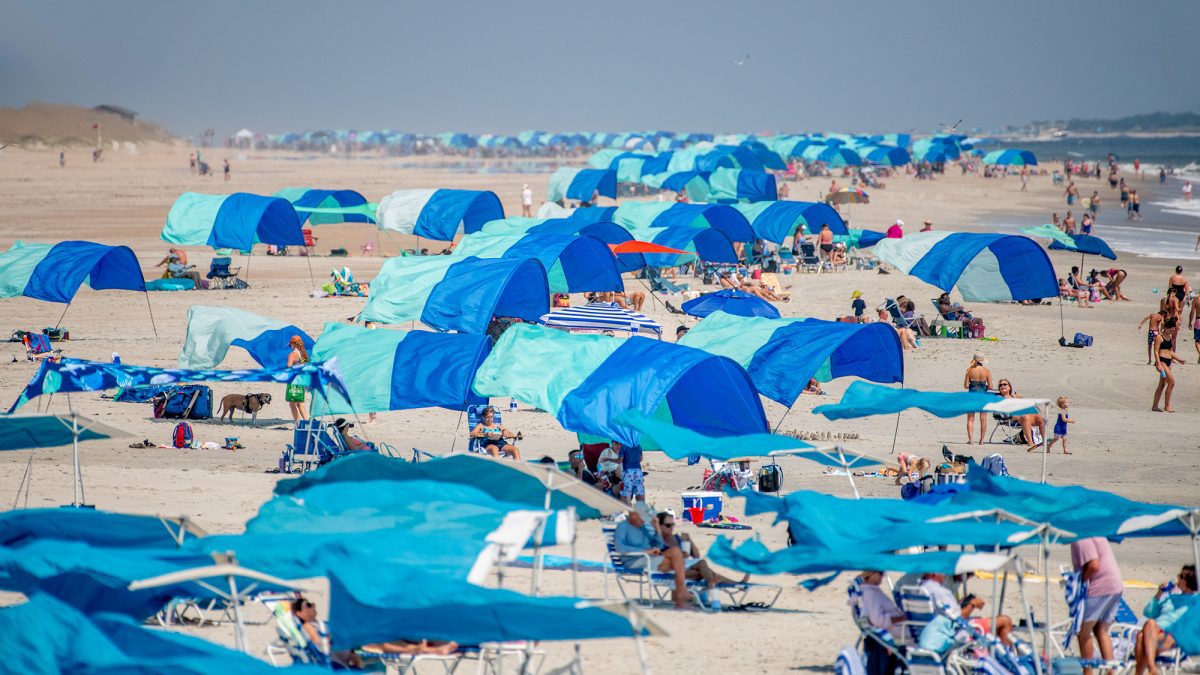 A sea of sunshades hug the shoreline recently in Atlantic Beach on Bogue Banks. Photo: Dylan Ray