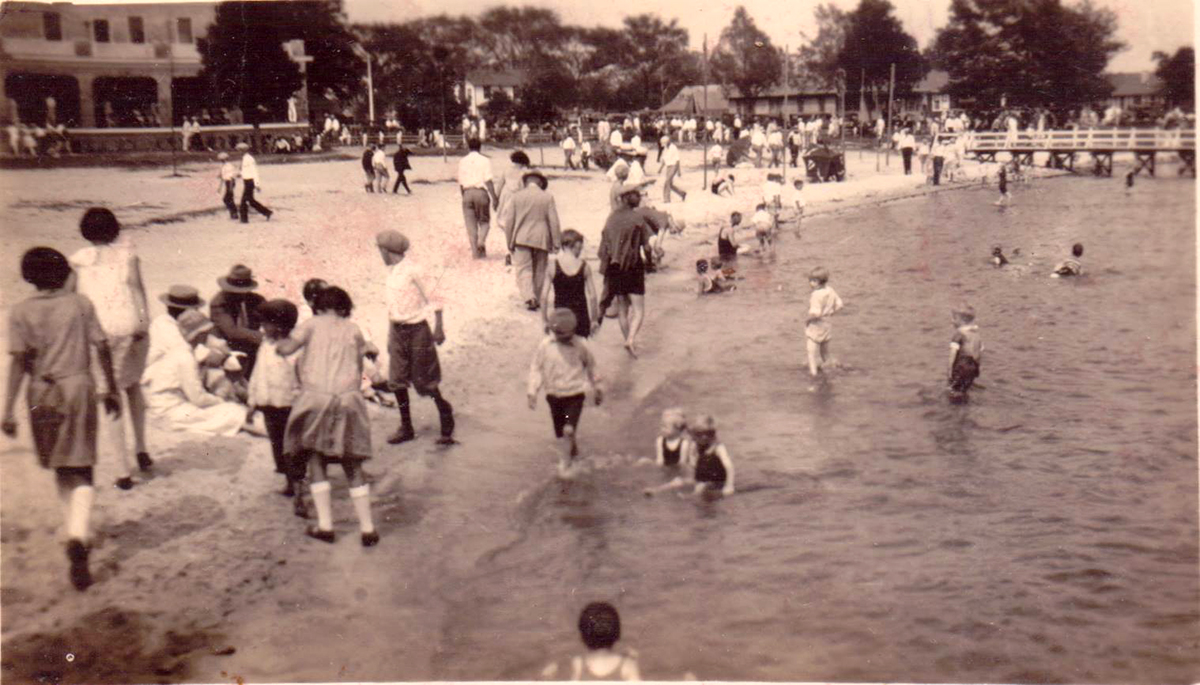 Guests at the Bayview Hotel flock to the sandy bank of the Pamlico River during the establishment's heyday. Photo courtesy Historic Port of Washington Project