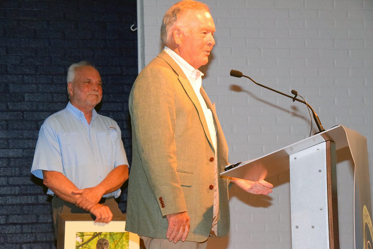 Derb Carter Jr. with Southern Environmental Law Center accepts his Distinguished Career Pelican Award Saturday as Todd Miller looks on. Photo: Mark Hibbs