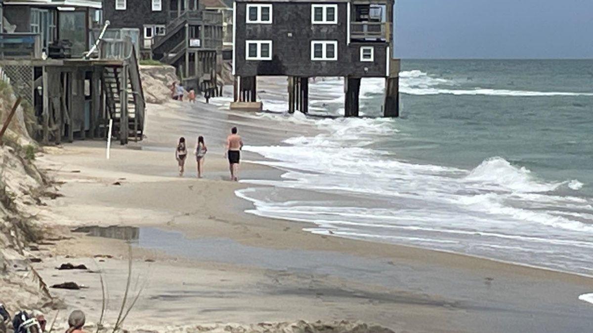 Beachgoers approach the house that collapsed last week in this National Park Service photo dated Aug. 12.