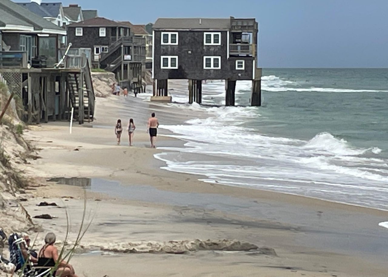 Beachgoers approach the house that collapsed last week in this National Park Service photo dated Aug. 12.