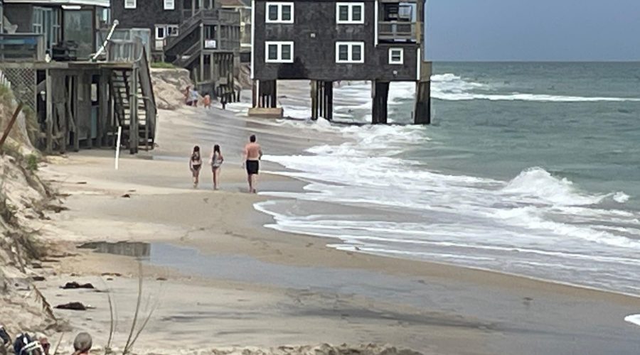 Beachgoers approach the house that collapsed last week in this National Park Service photo dated Aug. 12.