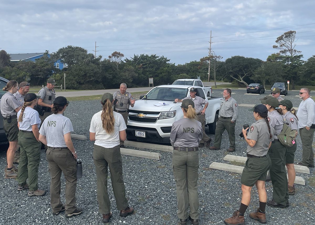 A gathering of Cape Hatteras National Seashore employees is shown during a safety briefing Wednesday prior to beginning work to clean up debris. Photo: National Park Service