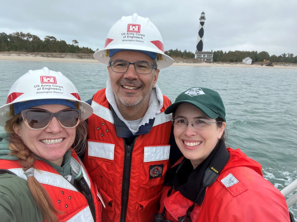 Dr. Andrea Currylow, left, and John Policarpo with Army Corps of Engineers celebrate the restoration of Sandbag Island with Carmen Johnson. Photo Credit: Andrea Currylow, Army Corps of Engineers
