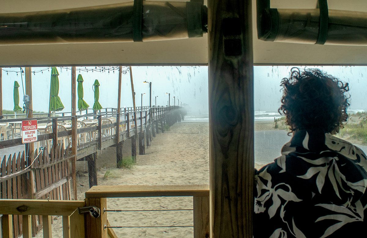 Tim Glennon of Morehead City watches the storm swell from Tropical Storm Helene Monday at the Oceanana Fishing Pier in Atlantic Beach. Photo: Dylan Ray