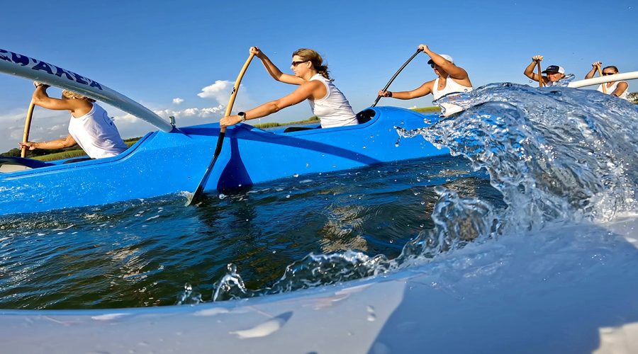 Kerri Allen, center, and her teammates on the Wrightsville Beach Outrigger Canoe Club are shown in action. Photo: North Carolina Coastal Federation