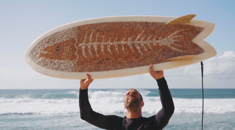 Musician Jack Johnson holds a surfboard made of cigarette butts, the focus of documentary, "The Cigarette Board" by filmmaker Ben Judkins. Photo: Ben Judkins