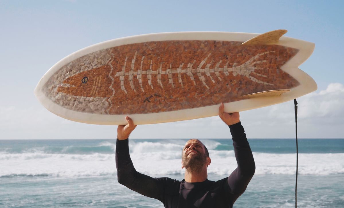 Musician Jack Johnson holds a surfboard made of cigarette butts, the focus of documentary, "The Cigarette Board" by filmmaker Ben Judkins. Photo: Ben Judkins