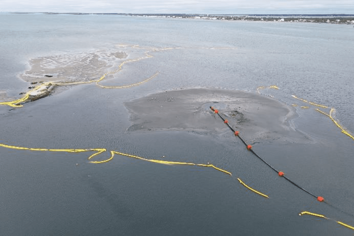 Aerial photo showing the island restoration in progress. The upper-left corner shows the remnants of the original Sandbag Island. A pipeline was used to pump material, and turbidity curtains were placed around the work area to help contain the material and protect nearby submerged aquatic vegetation. Photo: N.C. Wildlife Resources Commission