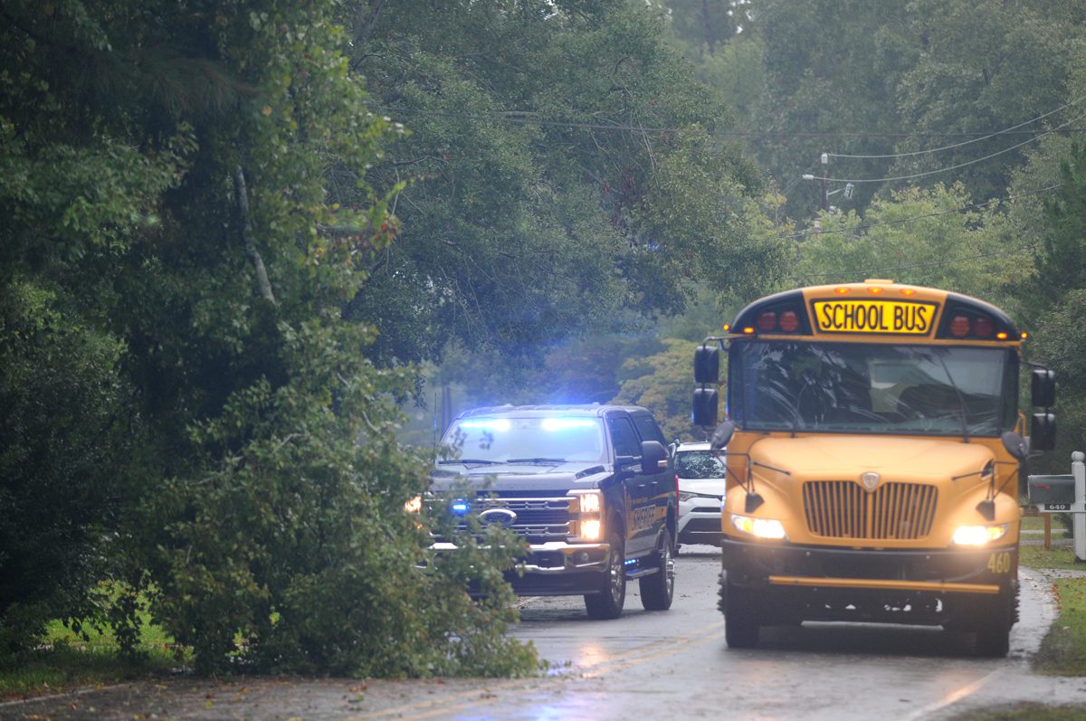 A New Hanover County Sheriffs deputy directs traffic around tree limbs blown down Monday during potential tropical cyclone No. 8. The limbs, blocking one lane of the road, came down in the 600 block of Bayshore Drive in Wilmington as the storm was approaching the South Carolina coast. Photo: Mark Courtney