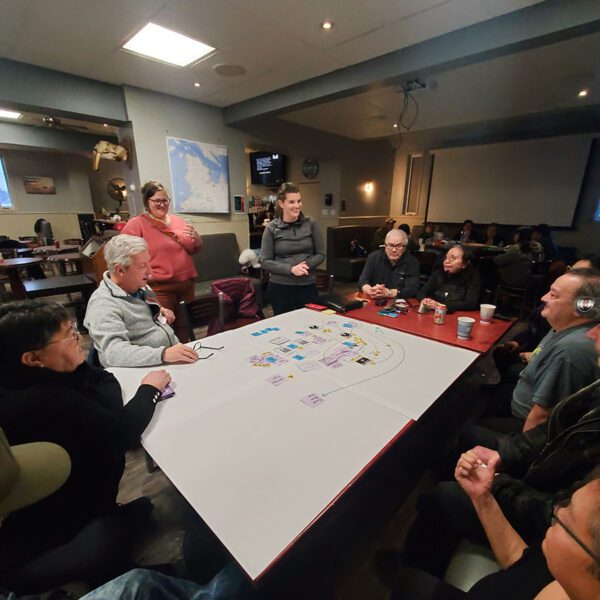 Samanth Farquhar, standing at center, discusses developing a commercial shrimping operation with residents of Quaqtaq, Quebec, Canada, in November 2023. Photo: Sonagnon Olivier Tokpanou