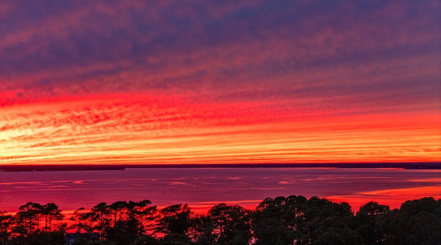 Striations of clouds blanket the sky at sunset over North River in Carteret County recently. Photo: Dylan Ray