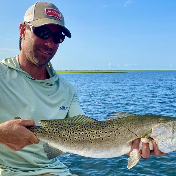 Neill Pollock shows off an 8-pound speckled trout caught on a topwater plug in one of Capt. Gordon’s hideaways. Photo: Gordon Churchill