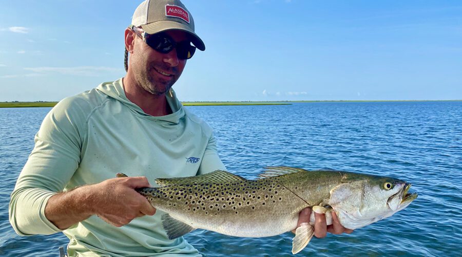 Neill Pollock shows off an 8-pound speckled trout caught on a topwater plug in one of Capt. Gordon’s hideaways. Photo: Gordon Churchill