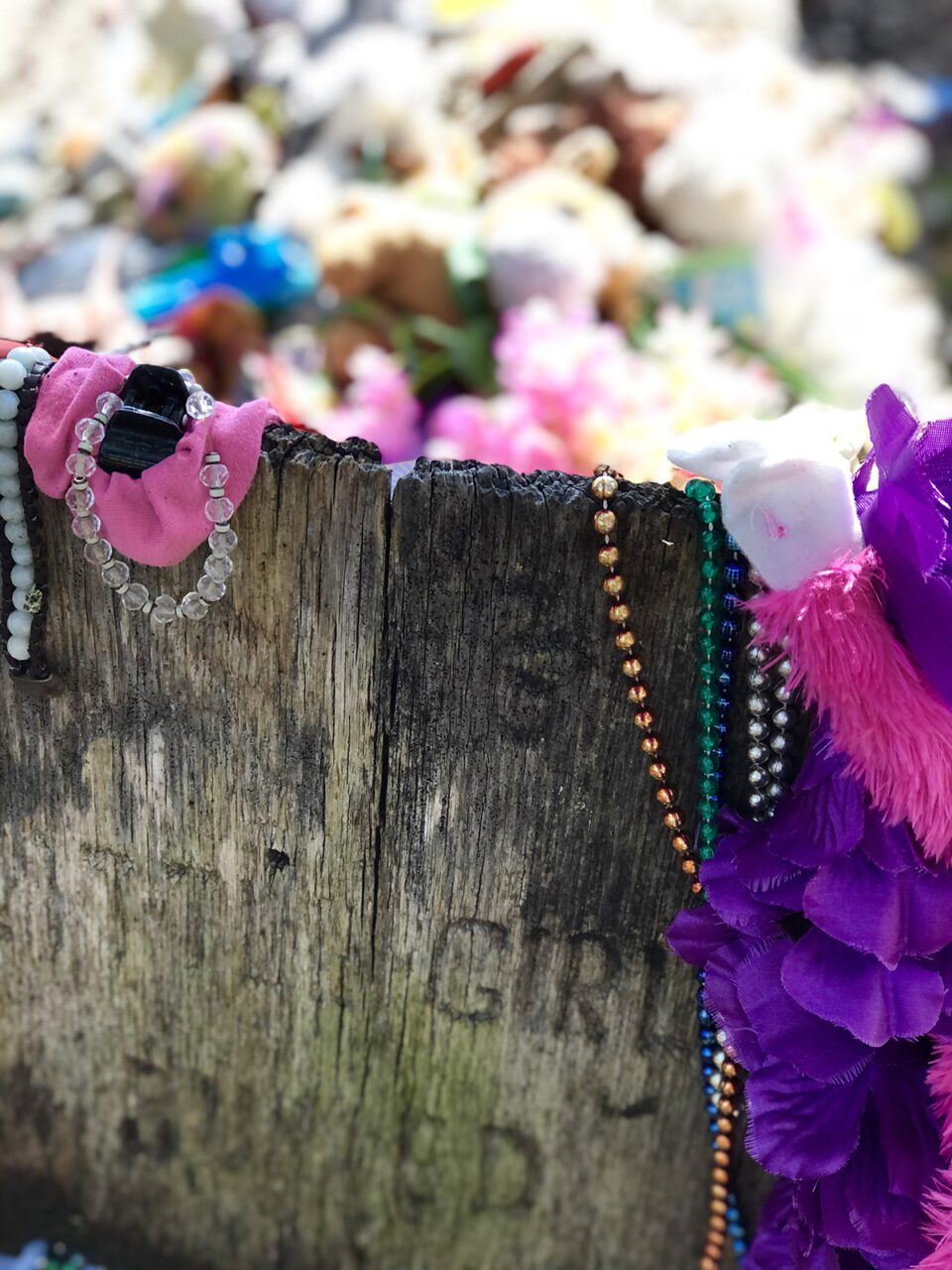 The grave is marked with a primitive looking wooden plank with the words “Little Girl Buried in Rum Keg” carved into the surface. Photo: Bright Walker