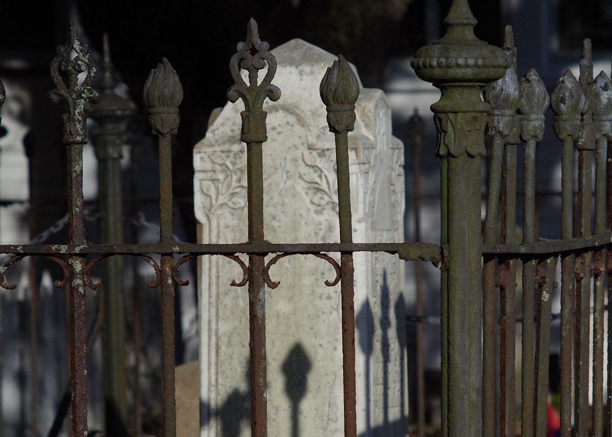 A rusty wrought-iron fence cordons off the centuries-old monuments and headstones in the Old Burying Ground in Beaufort. Photo: Mark Hibbs