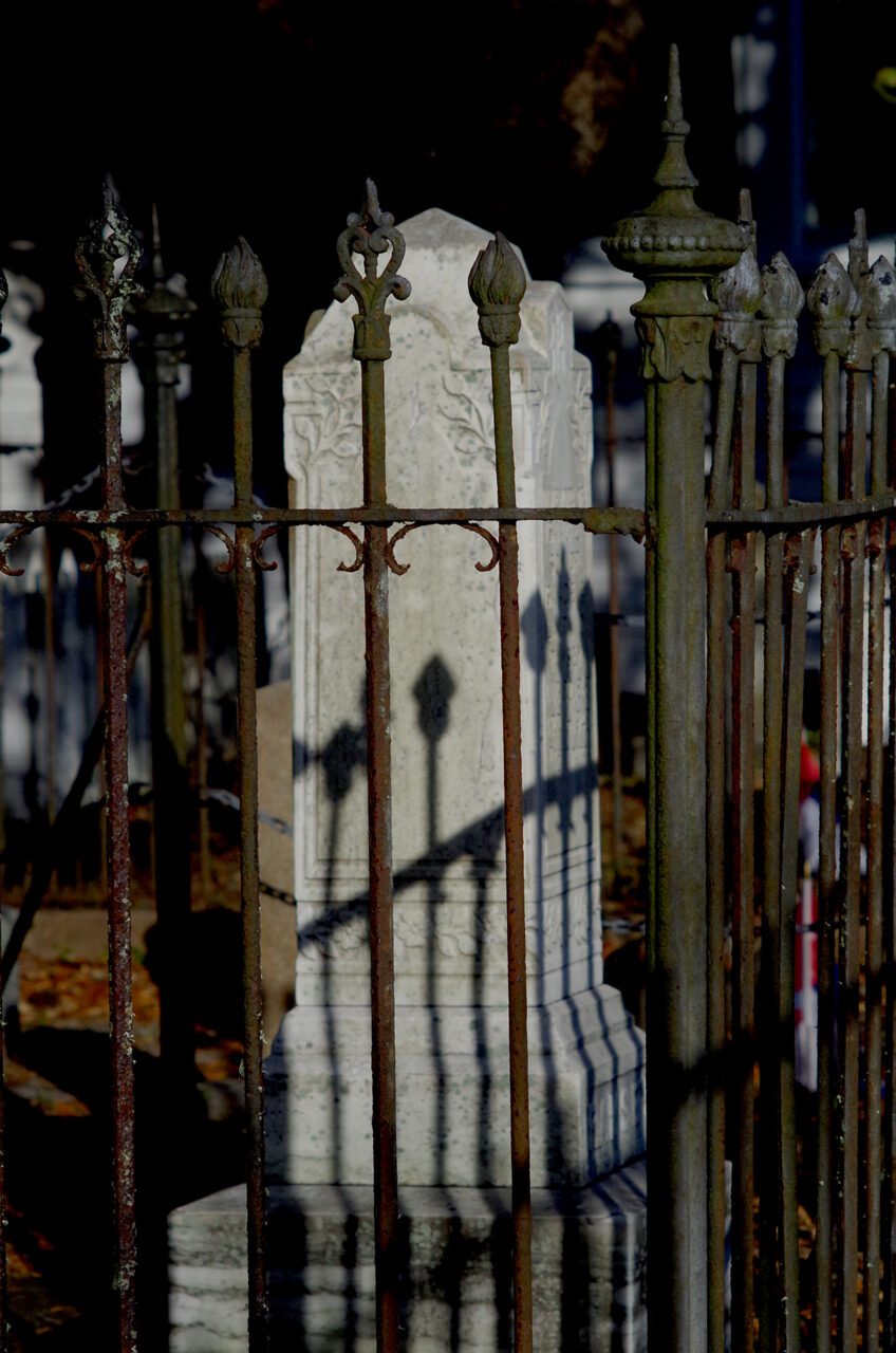 A rusty wrought-iron fence cordons off the centuries-old monuments and headstones in the Old Burying Ground in Beaufort. Photo: Mark Hibbs