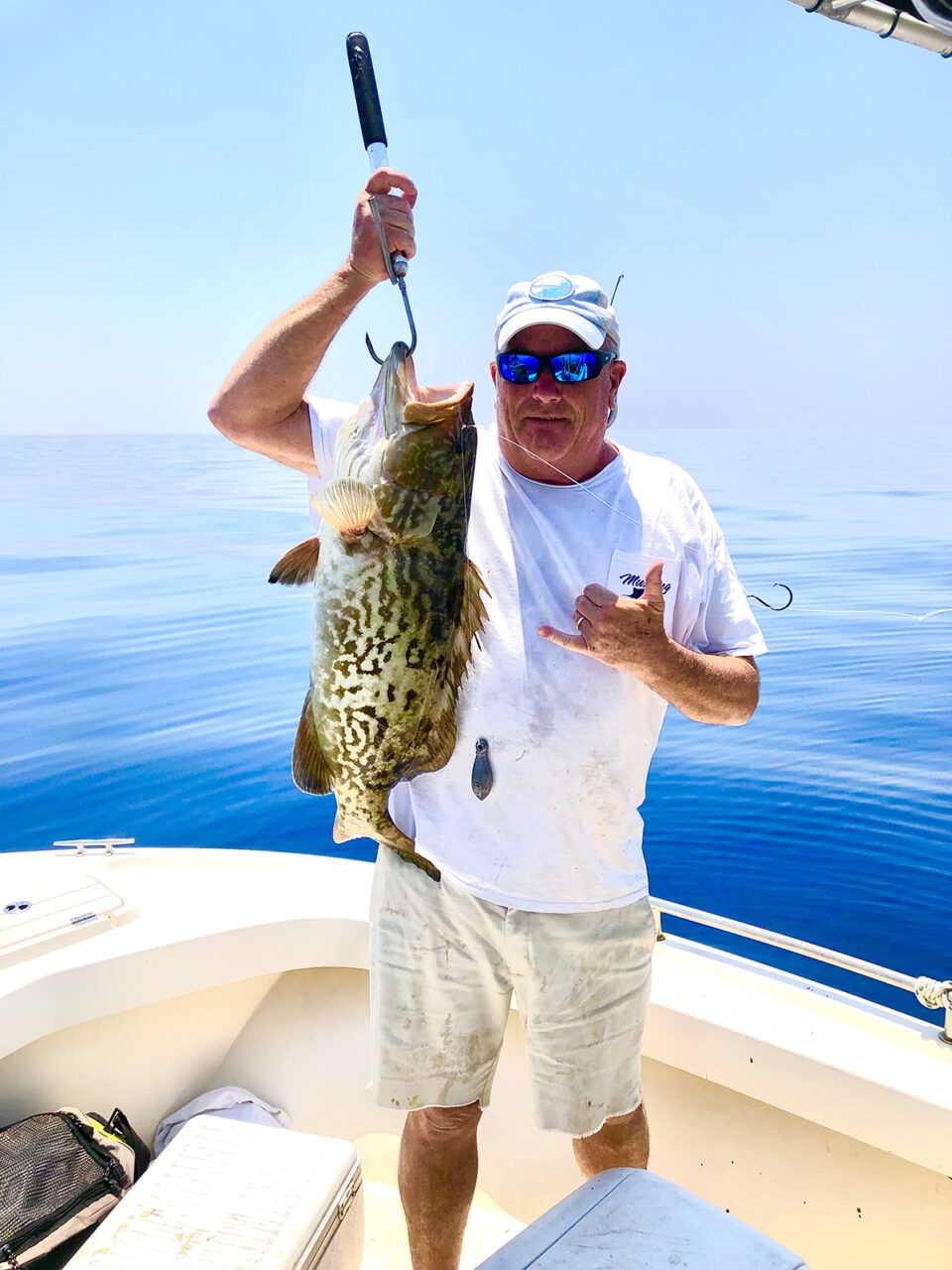 Coach Gilbert displays a quality grouper. Photo: Gordon Churchill