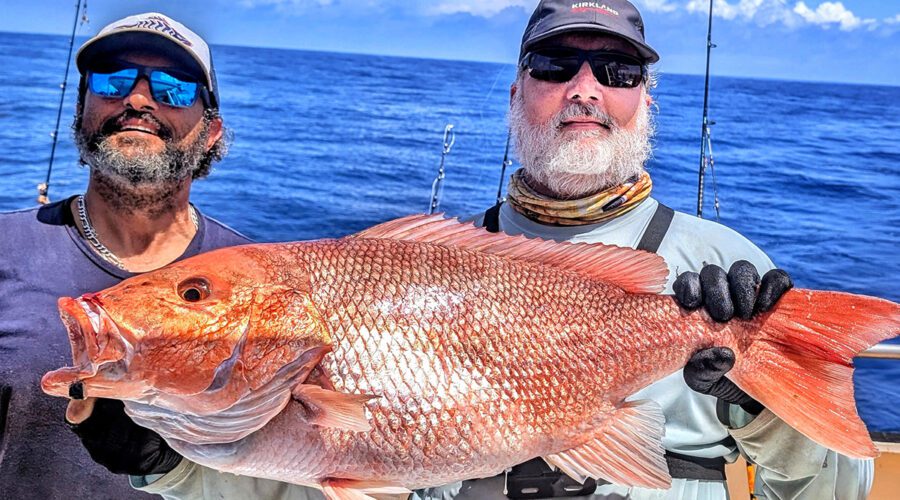 This snapper fell to Joel Elliot, right, and his jigging technique, with support from his Carolina Princess charter service mate Matt Buta. Photo: Gordon Churchill