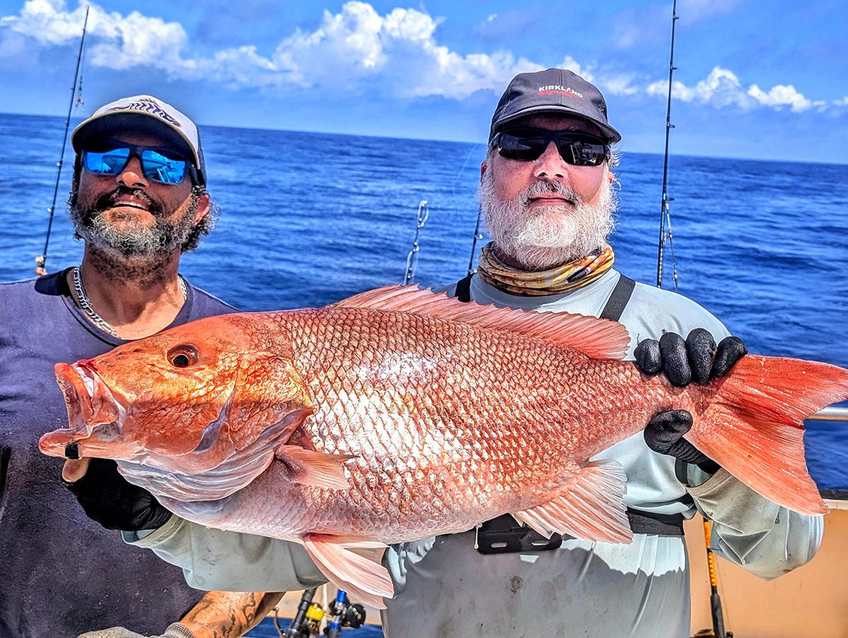 This snapper fell to Joel Elliot, right, and his jigging technique, with support from his Carolina Princess charter service mate Matt Buta. Photo: Gordon Churchill