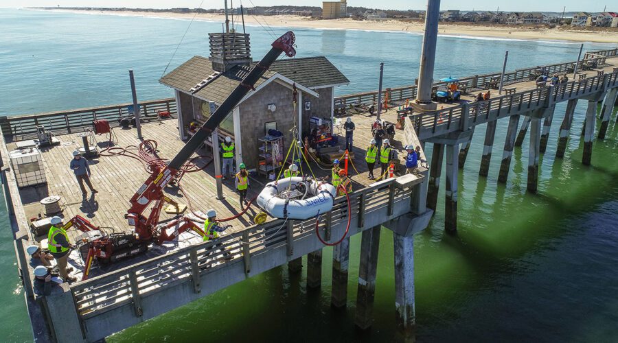 A wave energy converter is lowered over the side of Jennette’s pier in Nags Head. The device was tested in conjunction with the U.S. Department of Energy’s National Renewable Energy Laboratory and is designed to harness the power of waves to generate energy, and/or desalinate water. Photo: ECU