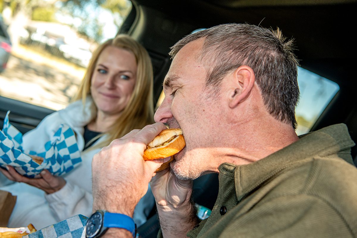 Amanda Lyle, left, watches as her husband Josh bites into an El's Drive-In "Superburger" Friday as they share a twenty-eight-year anniversary lunch at the Morehead City eatery. Photo: Dylan Ray