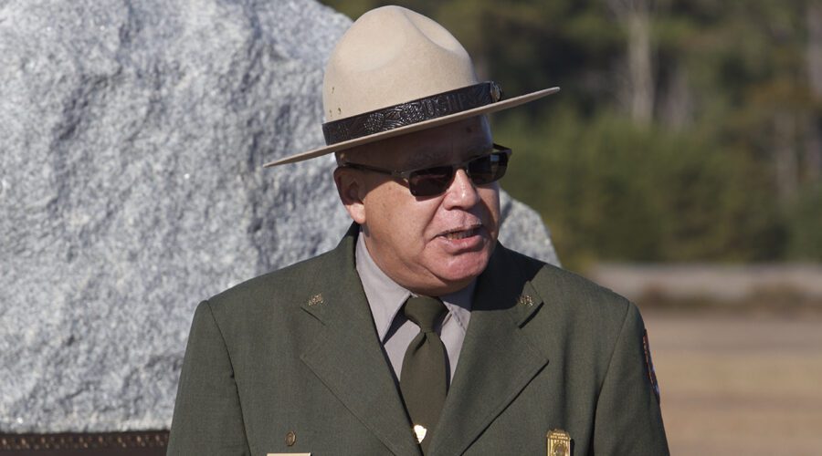 Ranger Darrell Collins, who died Dec. 24, 2024, is shown speaking in 2014 during a ceremony at the Wright Brothers Memorial honoring the 111th anniversary of the first flights. Photo: National Park Service