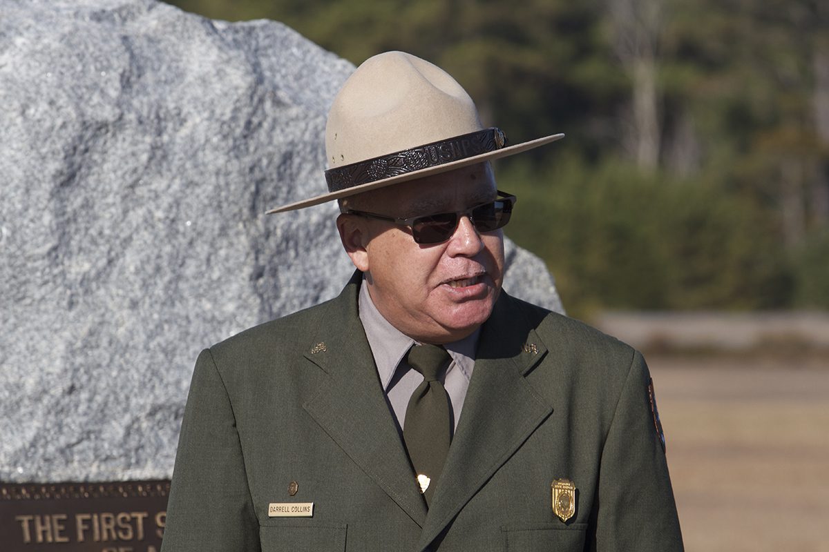 Ranger Darrell Collins, who died Dec. 24, 2024, is shown speaking in 2014 during a ceremony at the Wright Brothers Memorial honoring the 111th anniversary of the first flights. Photo: National Park Service