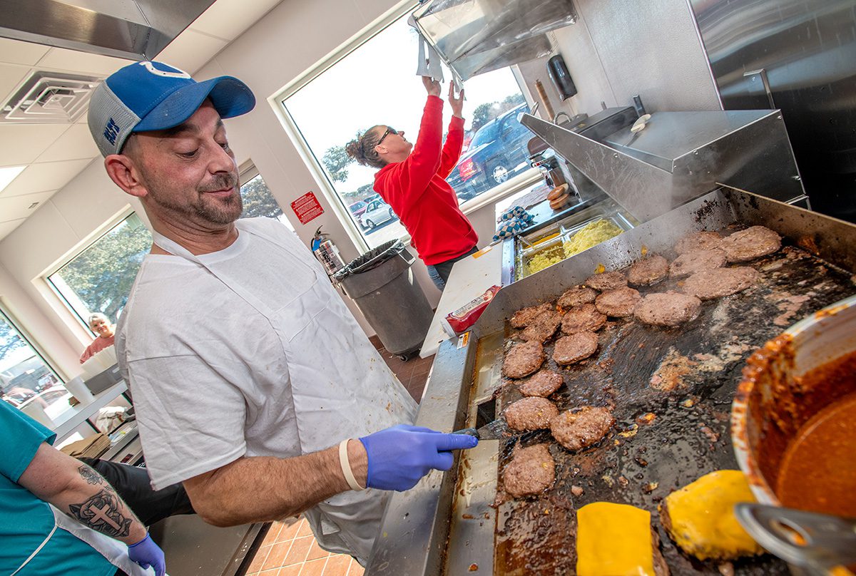 Allen Magara works the grill Friday during the reopening of El's Drive-In in Morehead City. Photo: Dylan Ray