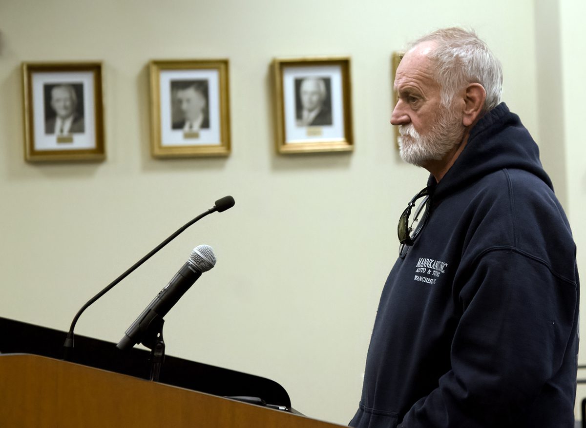 Wanchese resident Craig Parker, who lives next to the cluster home site, speaks Wednesday during the county commissioners meeting in Manteo. Photo: Kip Tabb