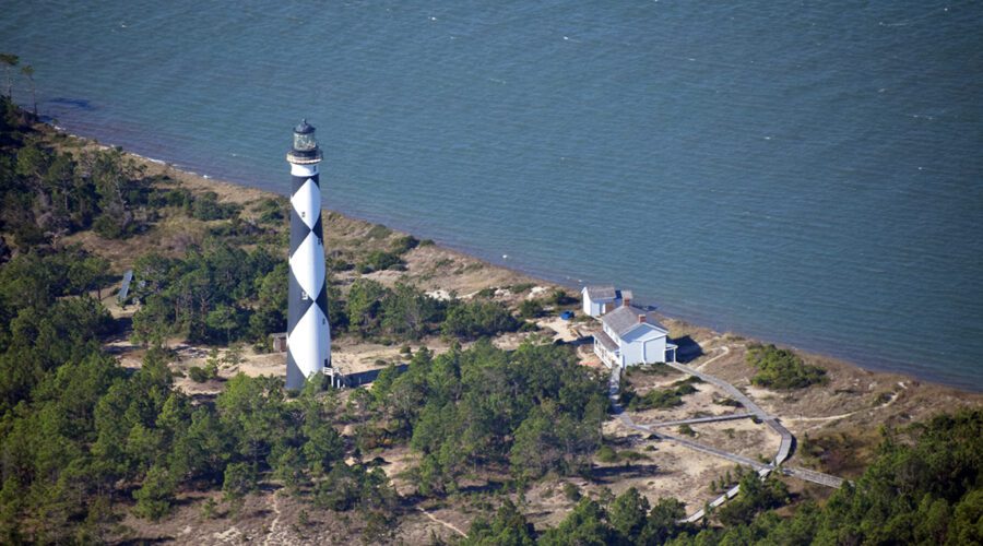 Cape Lookout Lighthouse and associated structures are shown during an astronomically high tide in August 2021, prior to a beach nourishment project on the sound side of the island. Photo: Mark Hibbs