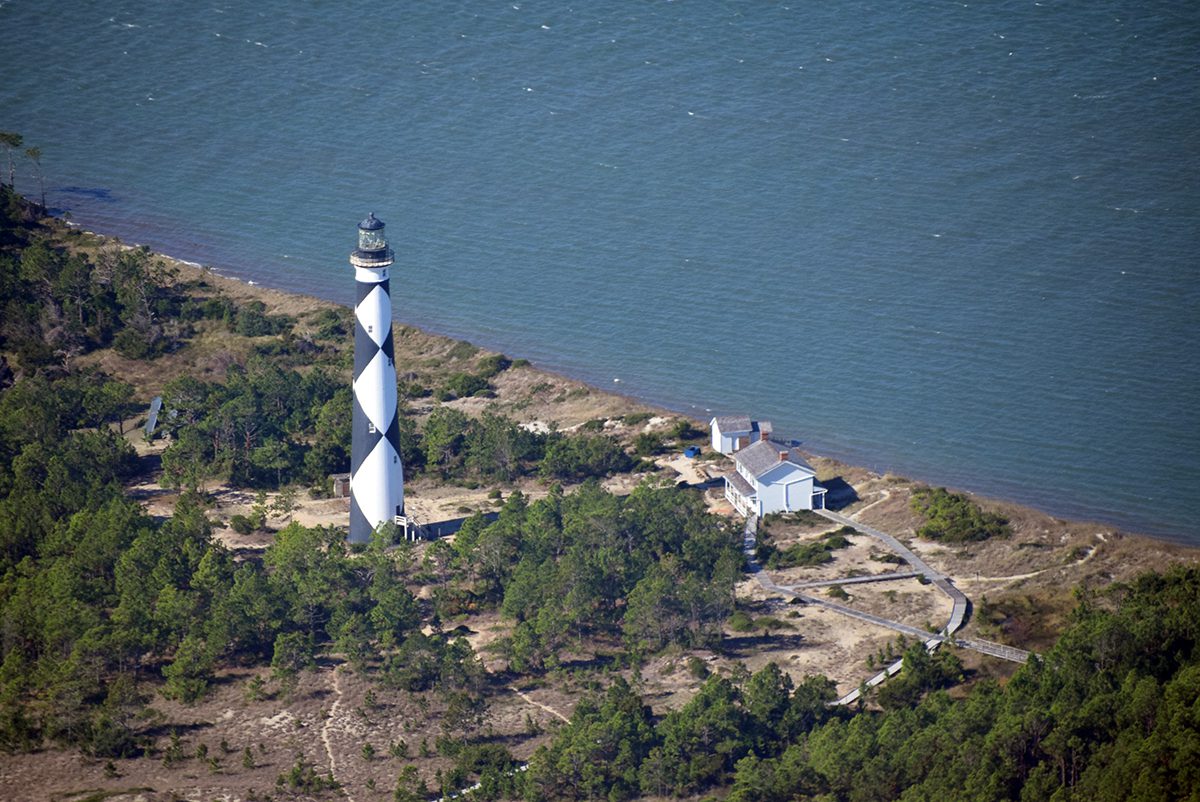 Cape Lookout Lighthouse and associated structures are shown during an astronomically high tide in August 2021, prior to a beach nourishment project on the sound side of the island. Photo: Mark Hibbs