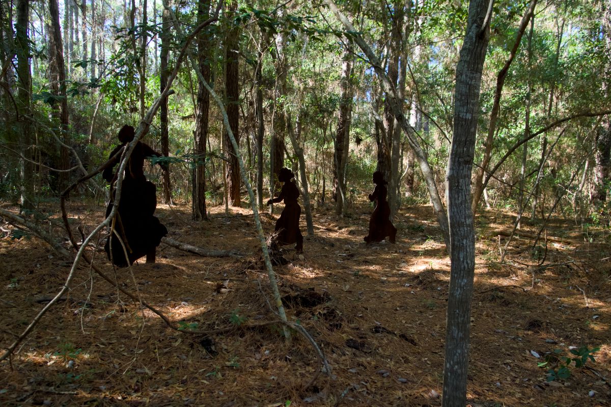 Behind the interpretive sign telling the story of Roanoke Island before the Civil War and Marie Ferribee Watkins are silhouettes representing Watkins, her mother, Annice Jackson, and sister, Alice. Photo: Kip Tabb