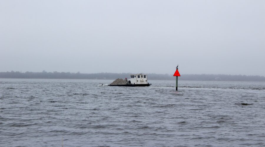 A Division of Marine Fisheries shallow-draft barge heads Wednesday to deposit material to the artificial reef site located just offshore of Carolina Beach State Park. Photo: North Carolina Coastal Federation