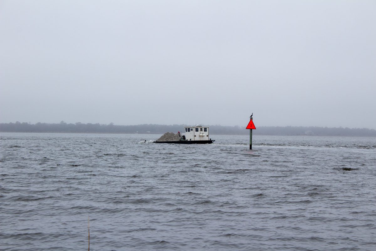 A Division of Marine Fisheries shallow-draft barge heads Wednesday to deposit material to the artificial reef site located just offshore of Carolina Beach State Park. Photo: North Carolina Coastal Federation