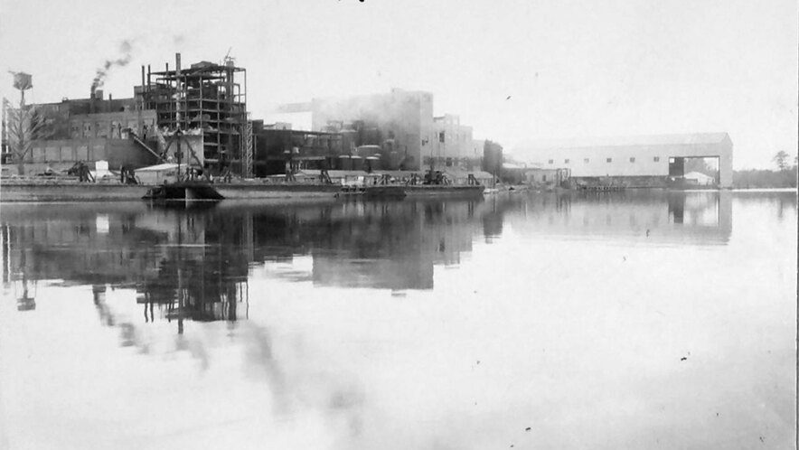 The North Carolina Pulp Company’s mill, Roanoke River, Nov. 1945. The company was a division of the Kieckhefer Container Company, a pioneering maker of shipping containers, paperboard (cardboard, fiberboard, etc.), and milk cartons. The use of pulp wood in the manufacture of corrugated and fibre boxes for use as food containers (such as milk cartons) was not sanctioned in the U. S. until early in the 20th century. However, the business boomed in the 1920s and ’30s. Eyeing the coming of World War II, the company’s leaders, J. W. and Herbert Kieckefer, feared that they would soon no longer be able to important pulp wood from Scandinavia, their main supplier at the time. That concern led them to open the mill in Plymouth in 1937. The plant was vast: by 1940, the mill employed some 500 workers and the company employed another 800 loggers in its extensive forest holdings. The company’s woodyard sometimes held logs from as many as a quarter million trees at a time. (For more on the history of the Kieckhefer Container Company, see the Forest History Society’s on-line exhibit here.) Photo courtesy, State Archives of North Carolina